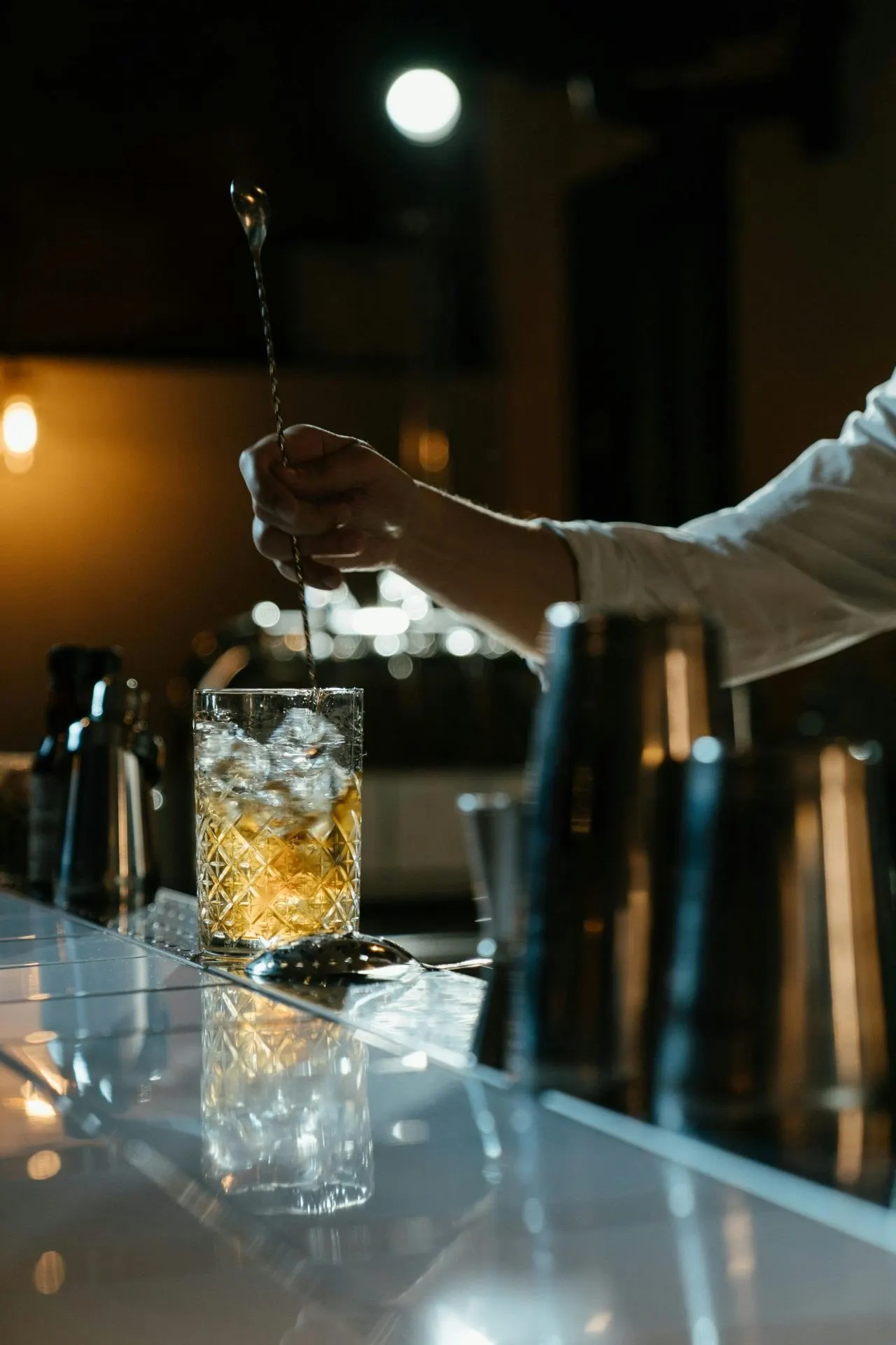 Bartender preparing a drink in a licensed bar - PC Licensing Consultancy Huntingdon