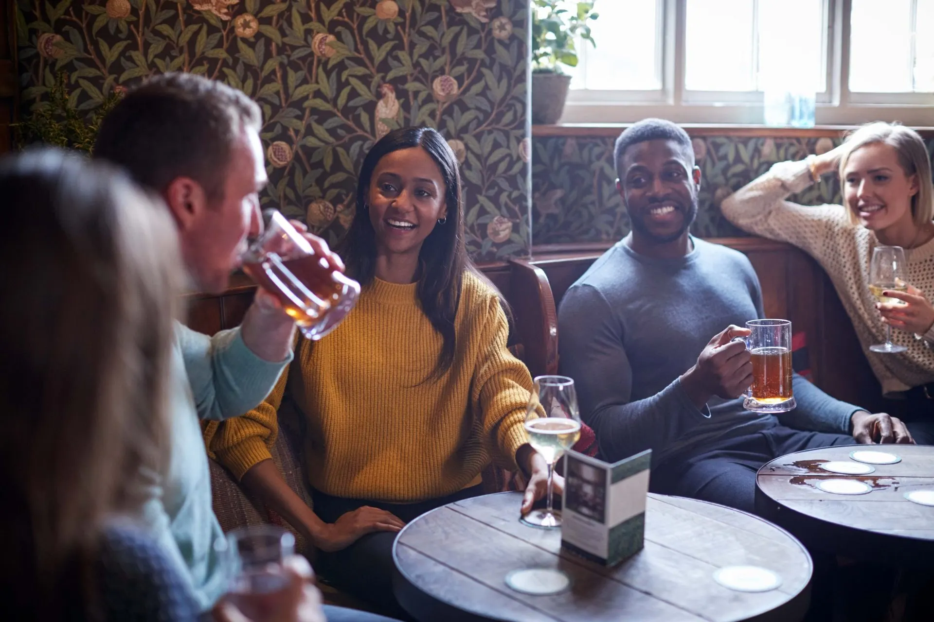 Friends enjoying drinks in a licensed pub - PC Licensing Consultancy